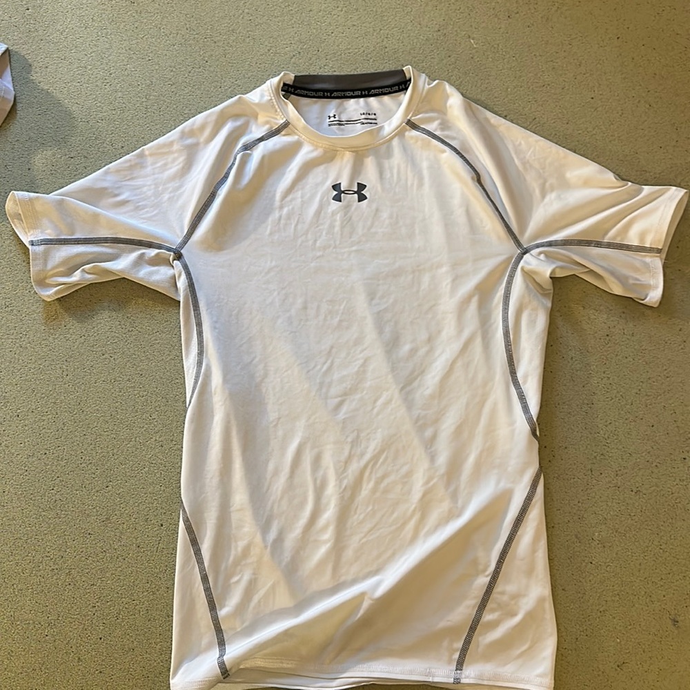 Used white Under Armour White short sleeve compression shirt.